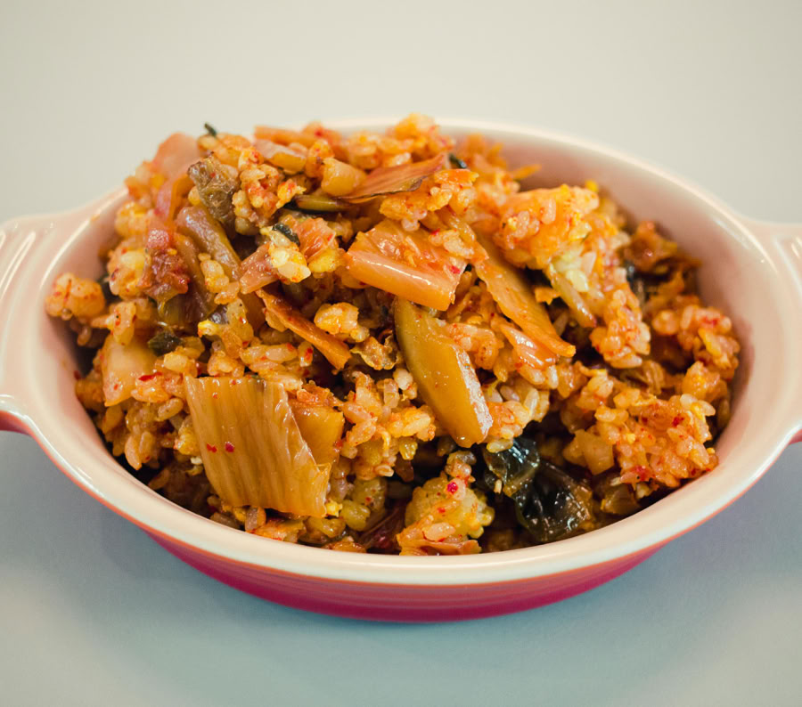 Tantalizing Korean Kimchi Fried Rice served in a ceramic bowl, showcasing vibrant colors and textures.
