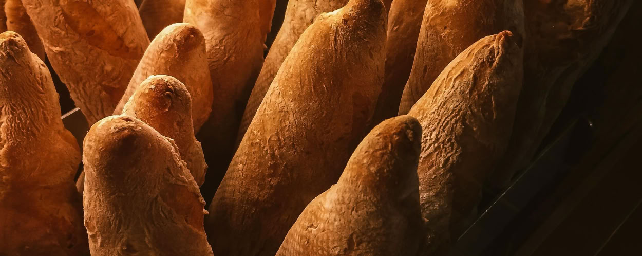 Golden baguettes displayed in a bakery, perfect for a delicious breakfast.