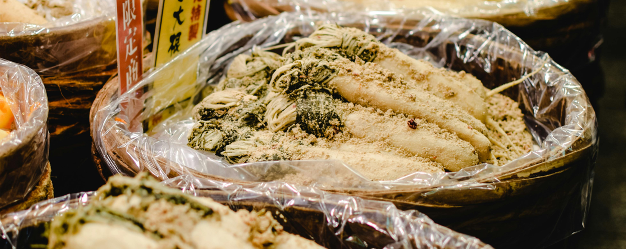 Variety of fermented vegetables on display at Nishiki Market in Kyoto, Japan.